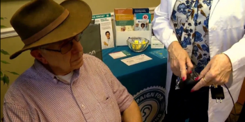 Isaac Allison receiving hearing aids from The Campaign for Better Hearing program during a fitting session.