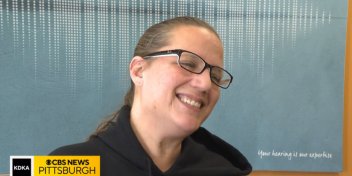 Christina Domedion smiles with gratitude after receiving complimentary hearing aids.