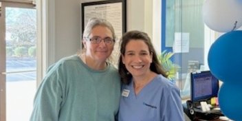 Hearing care professional with a patient inside a hearing clinic.