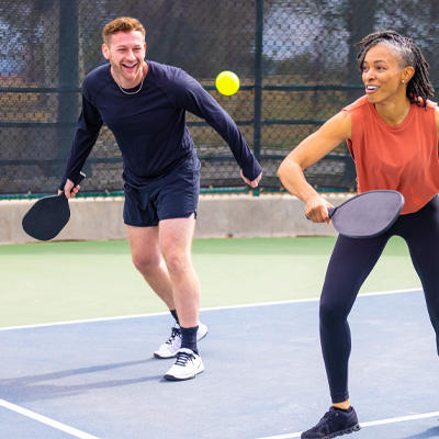 Couple playing pickleball