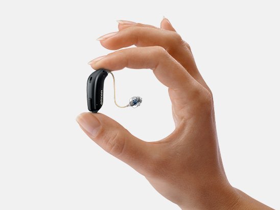 hand holding Oticon Jet PX hearing aid