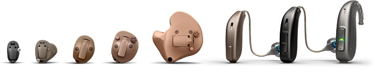 A row of hearing aids is arranged by size and type, ranging from in-the-ear models to behind-the-ear devices. The hearing aids are displayed on a white background.