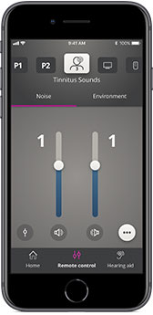 A smartphone displaying a hearing aid app interface with controls for ’Tinnitus Sounds’ featuring adjustable sliders for ’Noise’ and ’Environment’ set to level 1. The app offers options like ’Home,’ ’Remote Control,’ and ’Hearing Aid’ at the bottom navigation. Oticon branding or specific mention is not visible.
