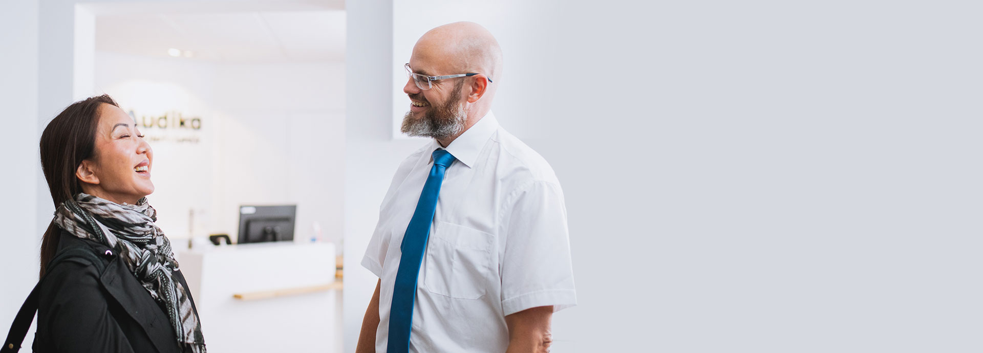 Hearing care specialist consulting a woman in a clinic setting
