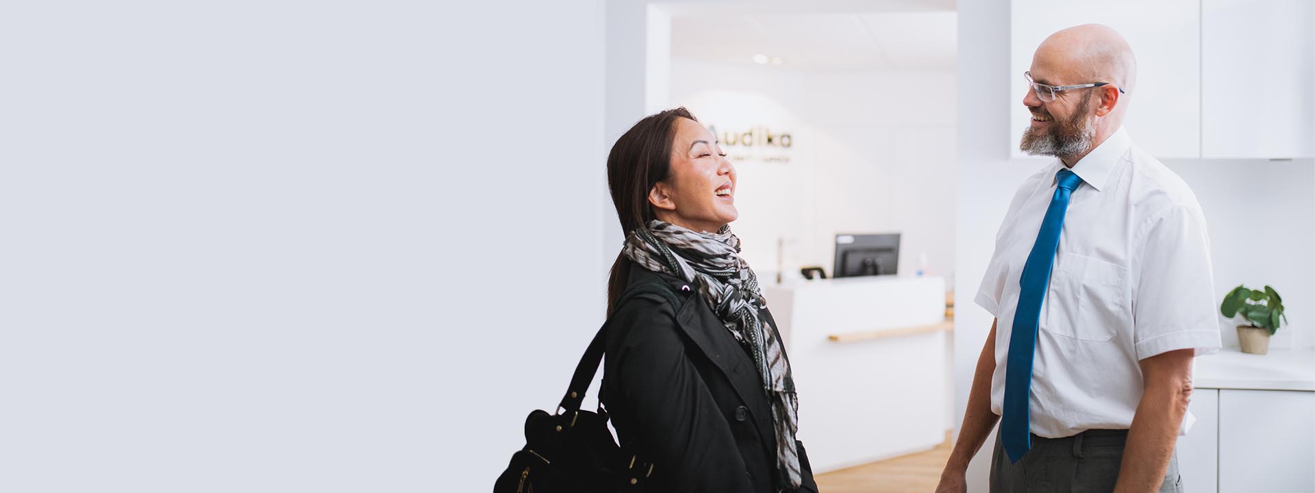 image shows woman talking to audiologist