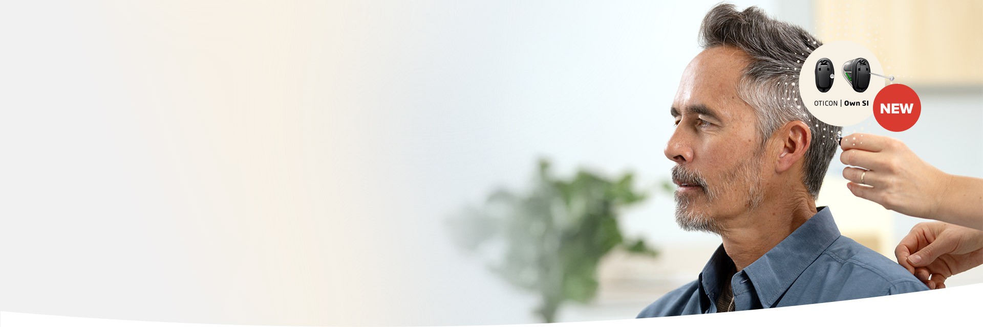 A clinician adjusts a discreet hearing aid on a seated man in a modern hearing clinic. Text reads, ’OTICON | Own S1 NEW,’ shown alongside images of the Oticon hearing aids.