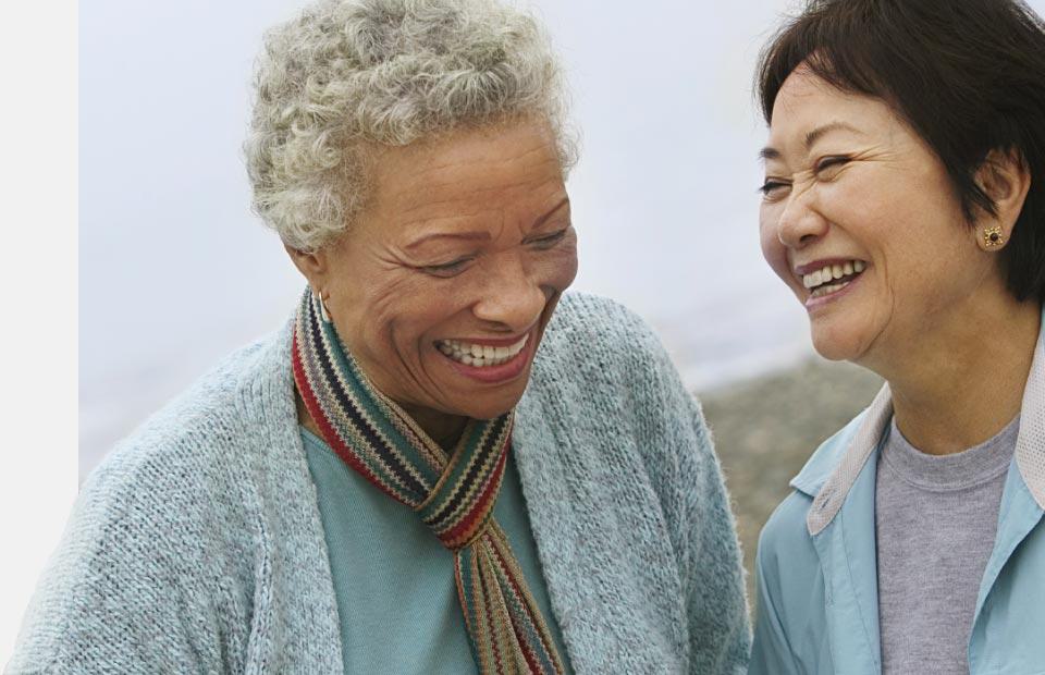 Women smiling and discussing the selection of hearing aids.