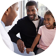 Family consulting with audiologist in a clinic setting.