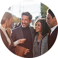 People conversing outdoors in a group setting