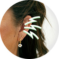 Image shows a woman holding her hands to her head