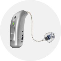 Silver Oticon hearing aid with sleek design and clear earpiece.