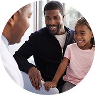 Family consulting with audiologist in a clinic setting.