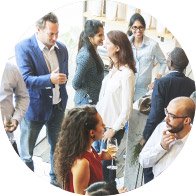 People engaged in lively group conversations at a social gathering.