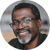 Smiling man wearing glasses in a professional setting.