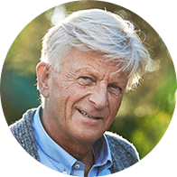 Elderly man with gray hair outdoors in natural sunlight