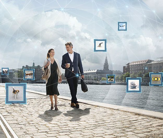 Couple walking along a harbour surrounded by visual representations of various sounds, including a dog, birds, and city noise.