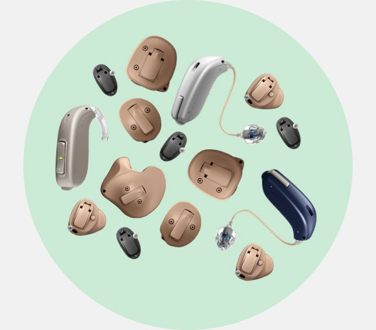 Hearing aids in diverse styles and colors, including in-ear and behind-ear designs, arranged in a circular layout on a light green background.
