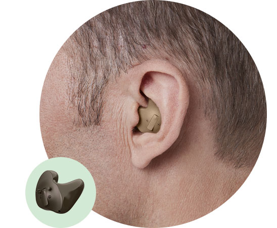 Beige hearing aid positioned in a man’s ear with short hair; an inset highlights the detailed design and features of the hearing aid.
