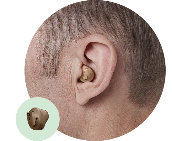 In-the-ear half shell hearing aid positioned comfortably inside an adult's ear.