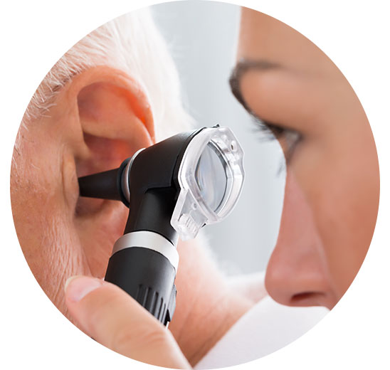 Healthcare professional using an otoscope to inspect a patient’s ear.