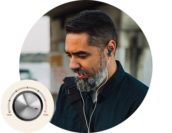 A man listens to audio through wired earbuds in an outdoor urban environment. A circular dial with ’min’ and ’max’ labels, resembling a volume control, is overlaid in the foreground.