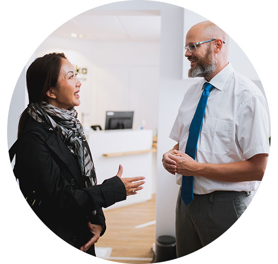 Woman consulting with a hearing care professional in a modern clinic.
